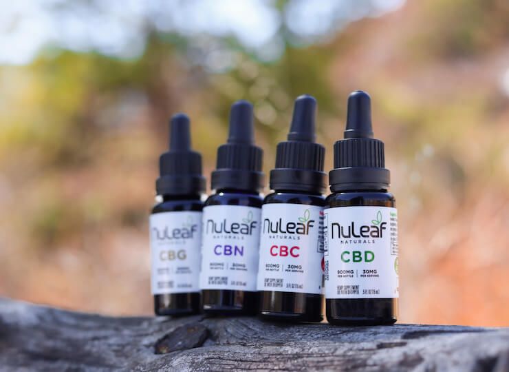 nuleaf cannabinoid product bottles on a rock